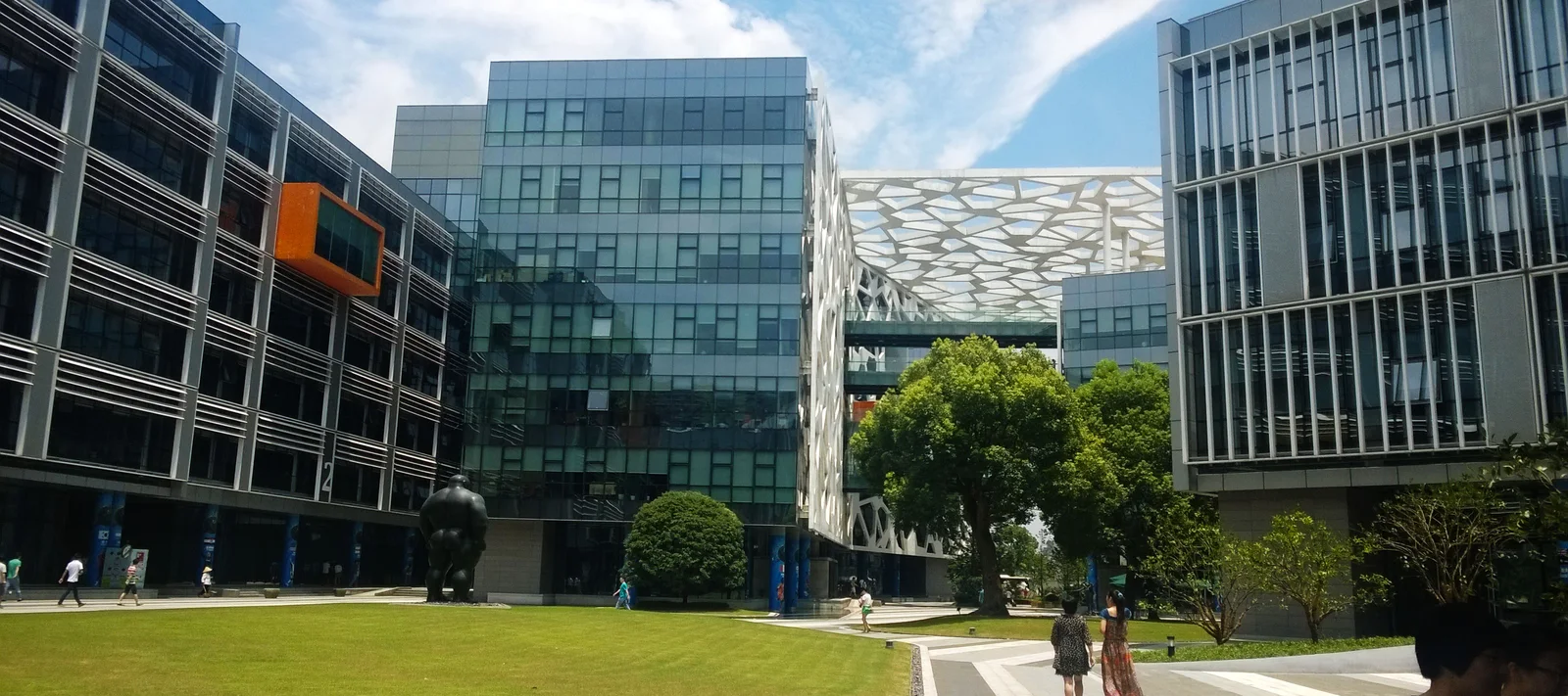 Glass office buildings and a lawn at Alibaba's Binjiang campus in Hangzhou.