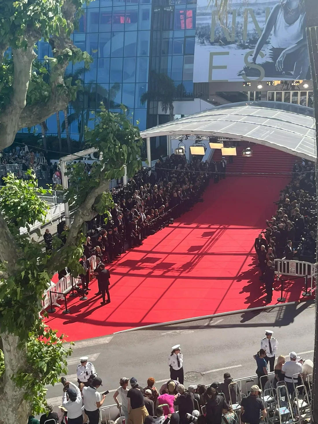 The red carpet at the Cannes Film Festival seen from above, photographers along both sides.